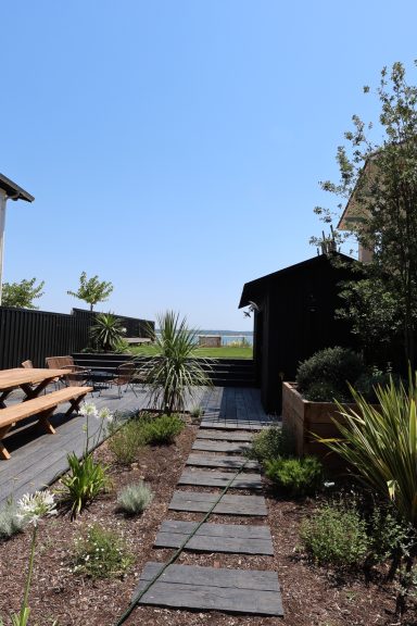 Jardin naturel avec cheminement en bois et vue sur le Bassin d’Arcachon.